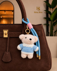 Portachiavi Teddy Sky azzurro e rosa su borsa marrone